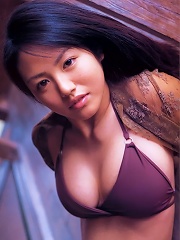 Flirtatious asian idol with large melons spilling from her bikini
